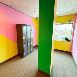 Photograph of a colourful common area with lockers in the BAO office