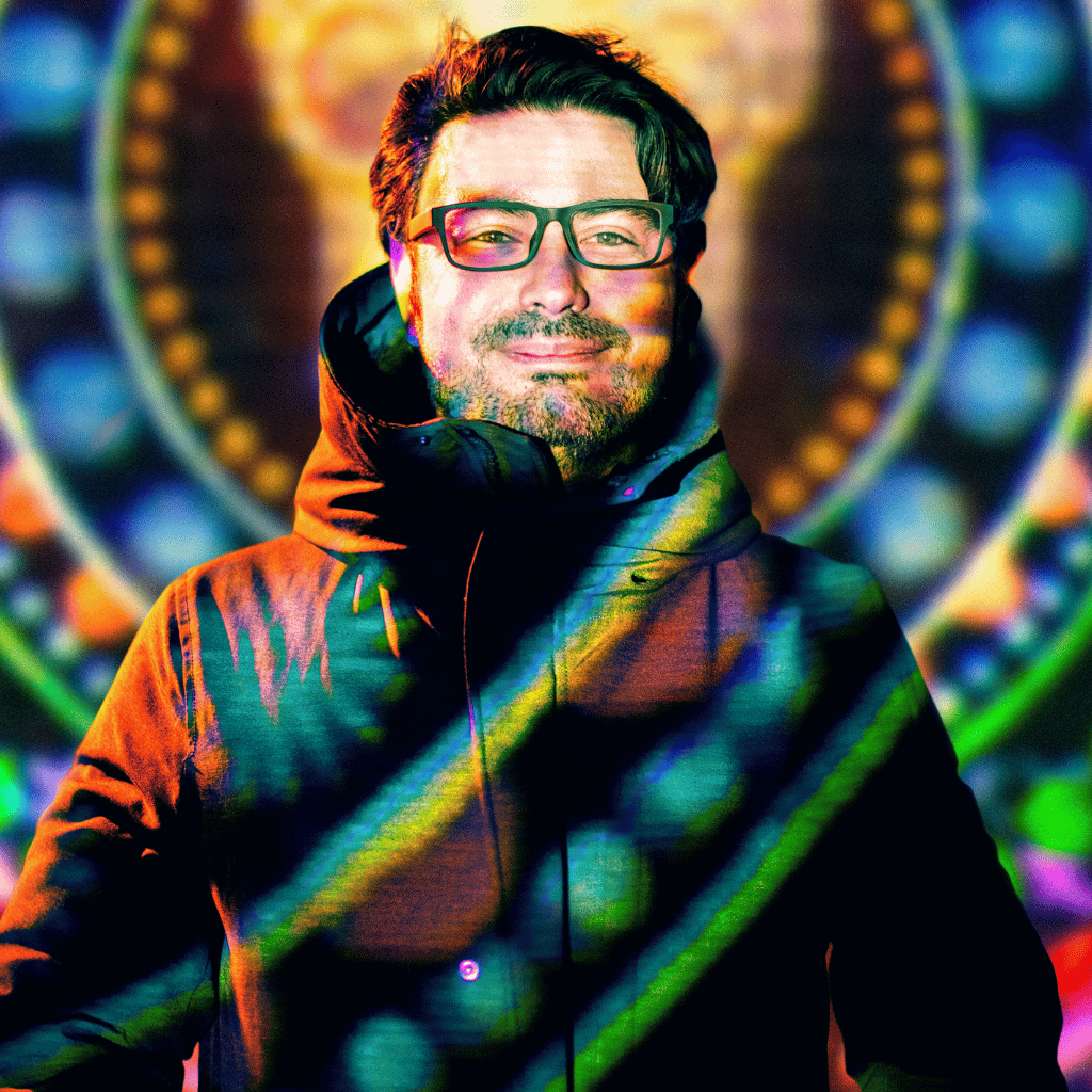 Photograph of Pedro Narváez Castellanos, a Latinx man who is wearing a black parka and glasses. He has a neatly trimmed beard.