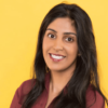 South Asian woman with long black hair, who is wearing a brown long sleeved button-up blouse
