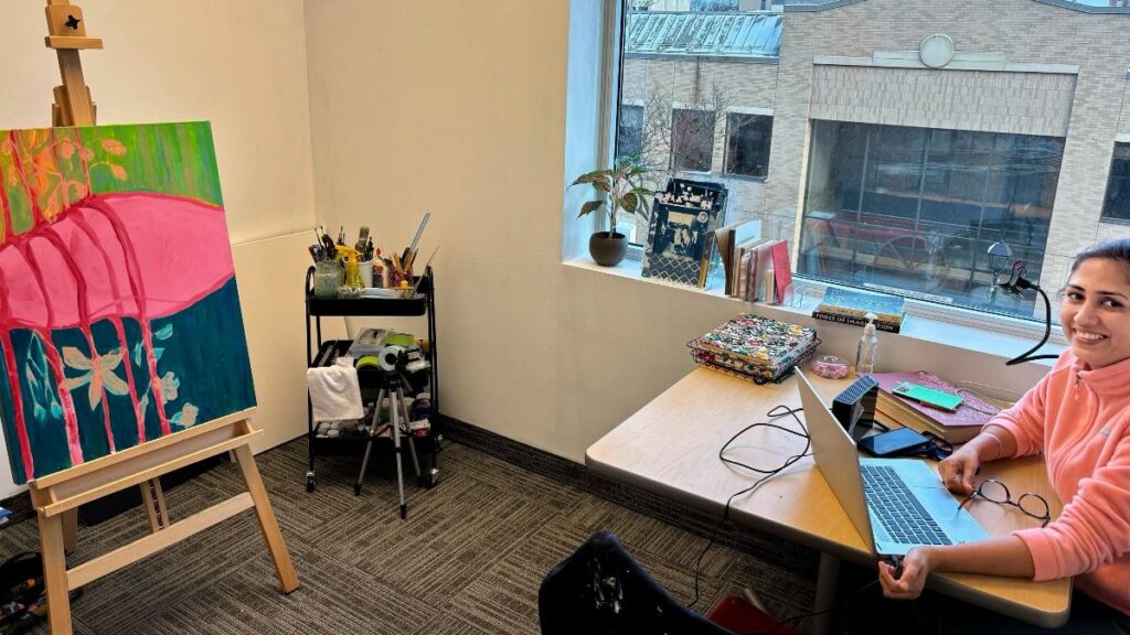 Photograph of Brampton artist Aditi Ganeev Sangwan working in her studio.