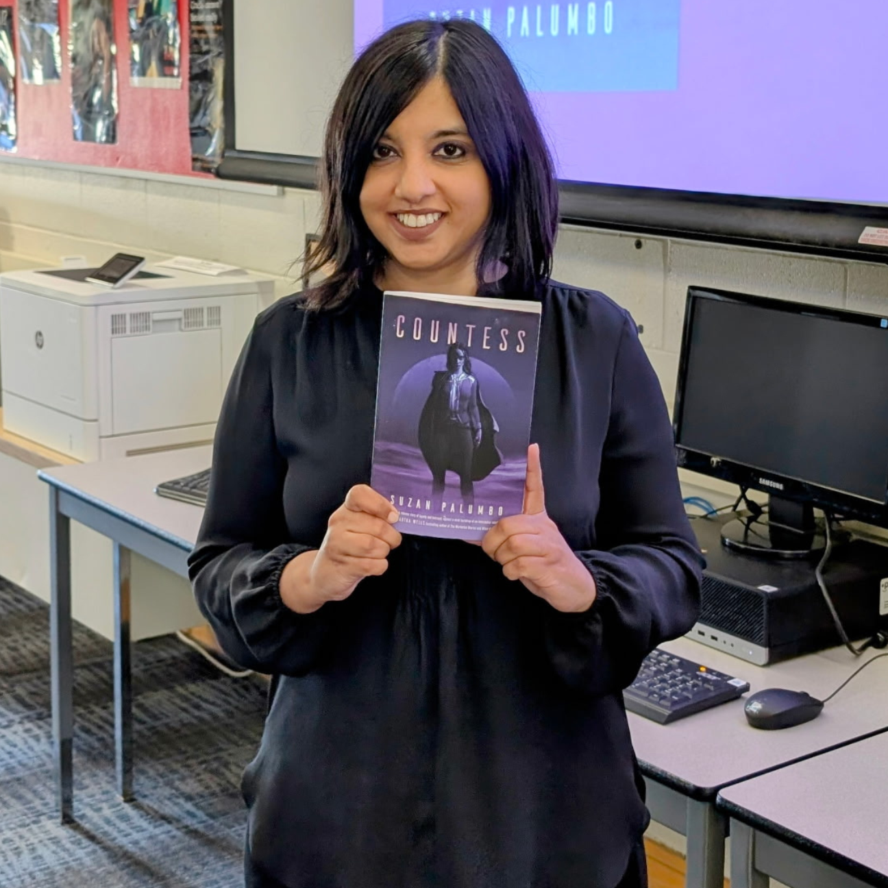 photograph of Suzan Palumbo, a young woman of colour with shoulder length black hair