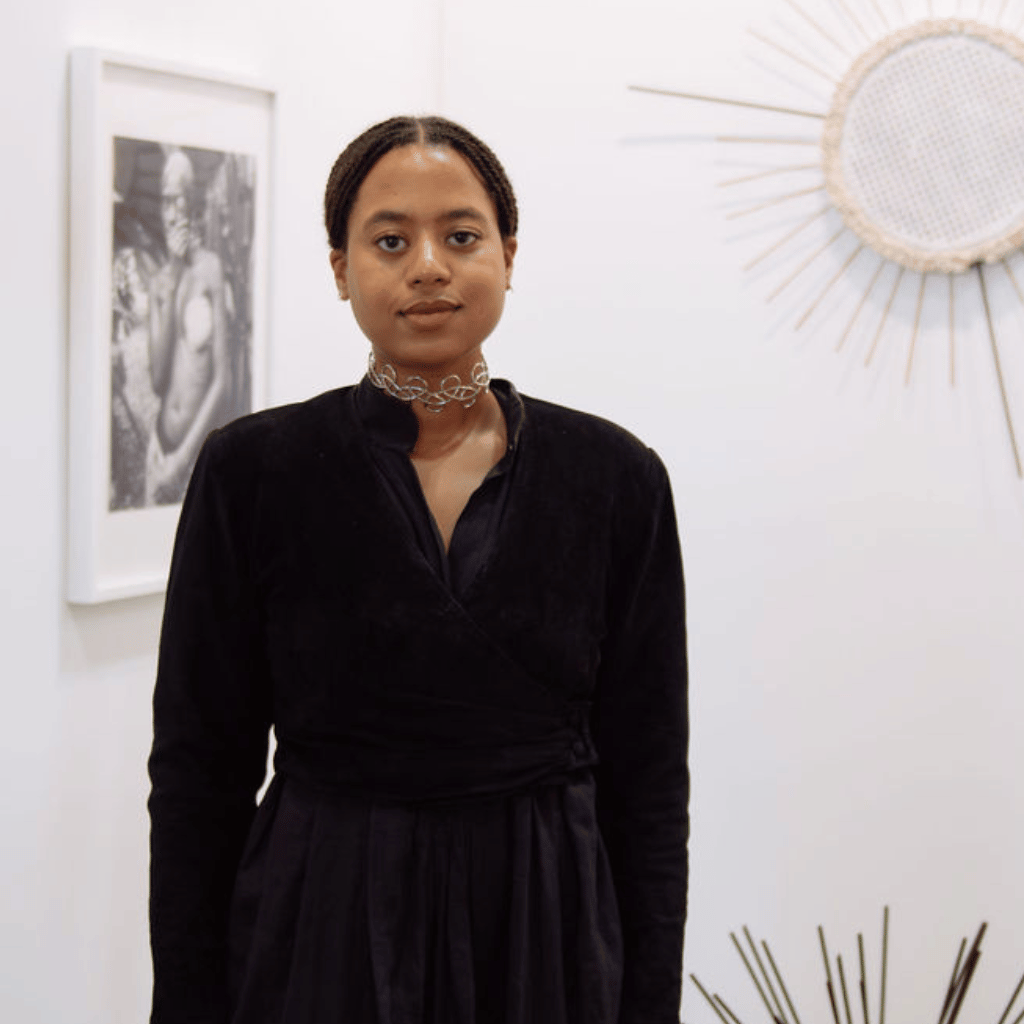 Photograph of Joséphine Denis, a Black woman with her hair pulled back. She is wearing a black dress and silver chocker.