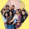 photograph of diverse Brampton artists cutting the ribbon for the BAO Studio rentals inside a stylized B-shape
