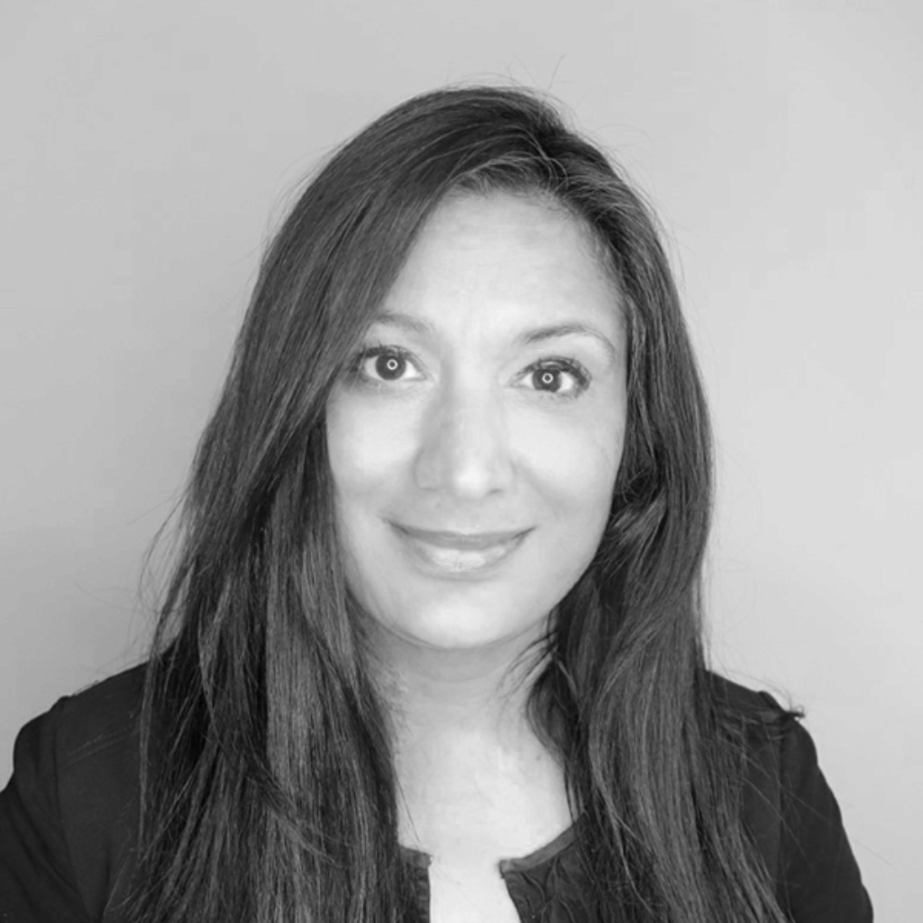 Black and white photograph of Vandana Taxali, a woman of colour with straight shoulder length hair.