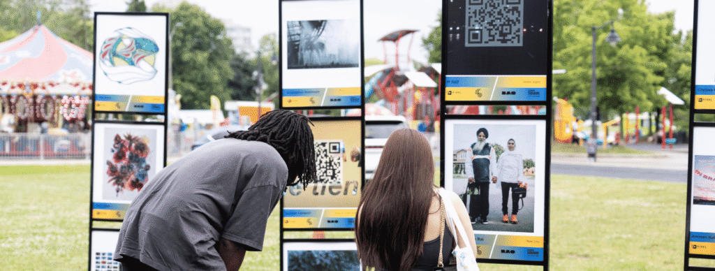 A man and woman looking at PIXEL: Chapter 50 art at the City of Brampton's 50th anniversary